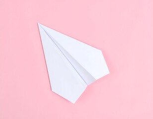 Simple folded paper airplane over pastel pink background delivering a message