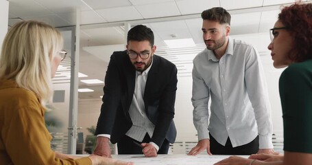 Group of diverse professionals making decision, evaluate data through visual analytics displayed in charts, planning corporate growth strategy, engaged in data analysis during teamwork in meeting room - Powered by Adobe