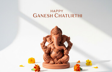 Minimalistic poster of a clay Lord Ganesha idol placed on a clean white background, marigold flowers, typography at Happy Ganesh Chaturthi&rsquo;