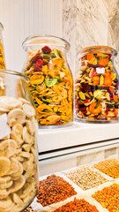 A variety of nuts and dried fruits displayed on a market stall.  Eco food, vegetarian diet, organic snacks, and healthy natural nutrition.
