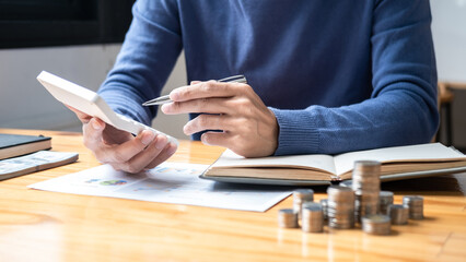 Young man and pile coins to planning growing saving strategy with pile coins for future plan fund of travel, education, home and retirement