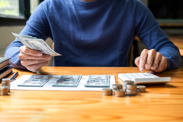 Young man and pile coins to planning growing saving strategy with pile coins for future plan fund of travel, education, home and retirement