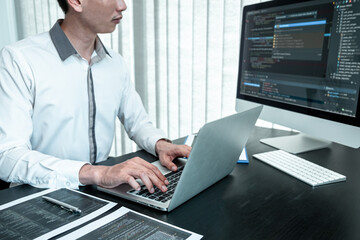 Young Programmer working in software javascript computer in IT office, Writing codes and data code website and coding database technologies to find solution to problem