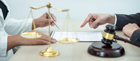 Male lawyer or counselor discussing negotiation legal case with client meeting with document contract in office, law and justice, attorney, lawsuit concept