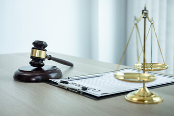 Judge gavel with Justice at law firm in background with legal case document contract, law and...