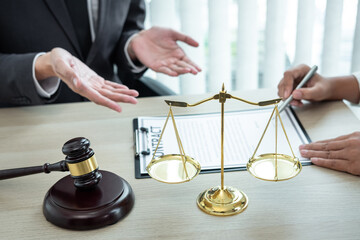 Male lawyer or counselor discussing negotiation legal case with client meeting with document...