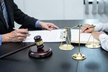 Male lawyer or counselor discussing negotiation legal case with client meeting with document...