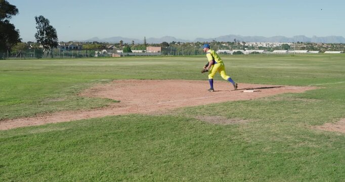 Recording out yellow-uniformed baseman catching ball after green runner rounding base, copy space
