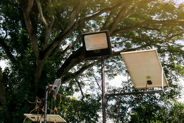 Solar Powered Spotlight with Blurred Green Trees