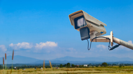 Surveillance Camera on Metal Rail with Blurred Fields