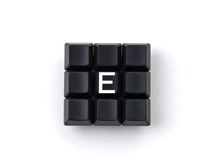 Typographic arrangement with letter E surrounded by dark keyboard buttons studio shot