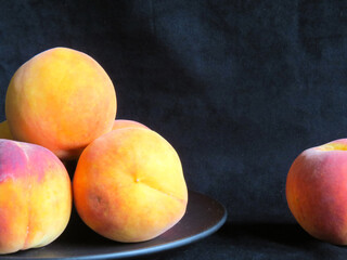 Peaches on black background. Fresh ripe organic fruits, whole and sliced peach, healthy food concept
