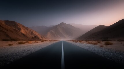 Naklejka premium Long road with mountains in the background. The road is empty and the sky is cloudy