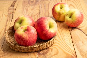 Sweet red apples on a wooden table, close-up.