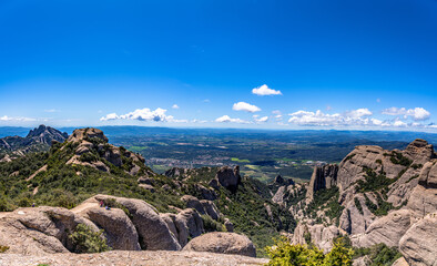 Panorama view of round rocky mountains of Sant Jeroni in Montserrat near Barcelona on a sunny spring day, Catalonia, Spain