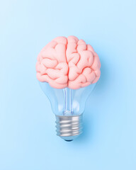 Creative representation of brain designed as light bulb, showcasing pastel blue background. This unique concept symbolizes intelligence