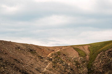 Two hikers on the trail to the  Essenbergspitz in in South Tyrol Alps in the late afternoon