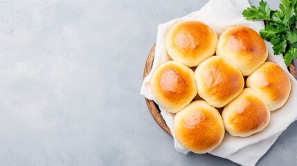 Overhead shot basket full of freshly baked dinner rolls with empty space for text.