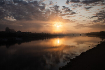 sunrise over the foggy river in Toruń