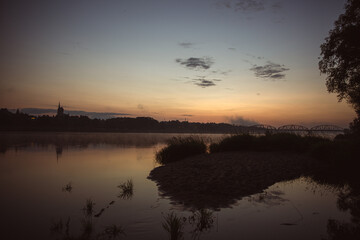 sunrise over the foggy river in Toruń