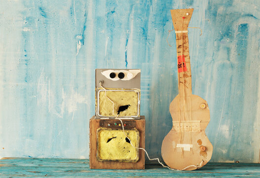 Grungy cardboard model of a guitar and an amp stack, rock and blues music, live performance,grunge rock concept
