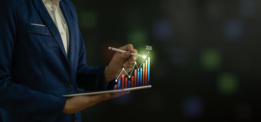 Businessman calculates financial data for long-term investments, analyzes profitability of working companies with digital augmented reality graphics, positive indicators in 2026.