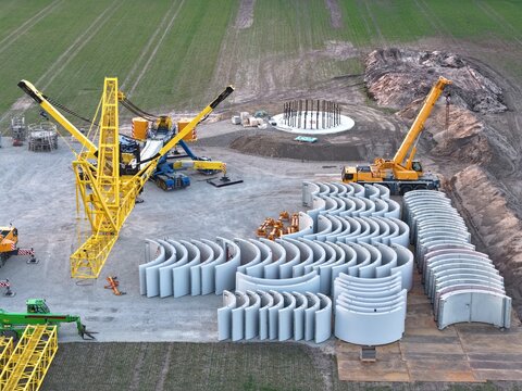 Large crane on the construction site of a wind turbine, aerial view, wind turbine, tower construction, renewable energies, energy transition, tower, prefabricated parts, hybrid tower, concrete parts
