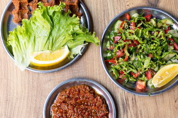 Making raw meatballs ( Turkish: Cig Kofte ) on wooden background	