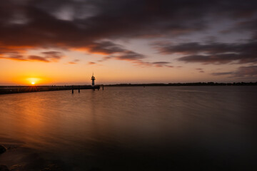 Beautiful sunrise at the lighthouse on Timmendorfer Strand.