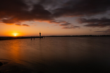 Beautiful sunrise at the lighthouse on Timmendorfer Strand.