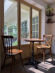 Cozy cafe interior with sunlight on table and chairs