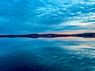 Sunset above the baltic sea in Örnsköldsvik harbor with water reflections, Sweden
