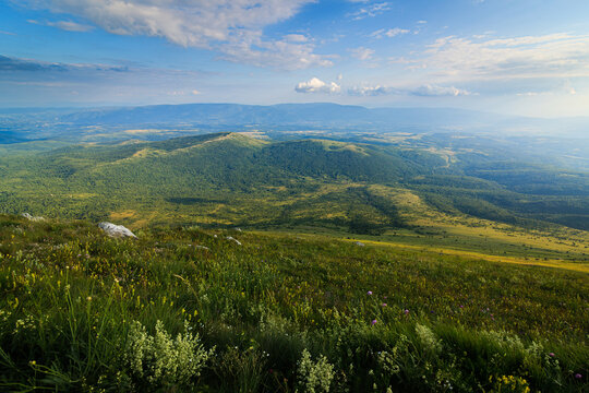 A picturesque view from the hiking path of Rtanj mountain in Eastern Serbia, showcasing its lush greenery and expansive landscapes.