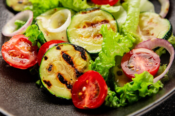 Salad grilled zucchini, tomato, lettuce tasty snack fresh delicious gourmet food background on the table rustic food top view copy space keto and paleo diet vegan and vegetarian food