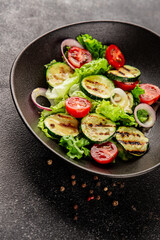 Salad grilled zucchini, tomato, lettuce tasty snack fresh delicious gourmet food background on the table rustic food top view copy space keto and paleo diet vegan and vegetarian food