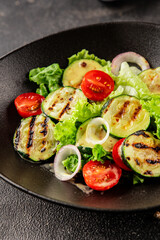 Salad grilled zucchini, tomato, lettuce tasty snack fresh delicious gourmet food background on the table rustic food top view copy space keto and paleo diet vegan and vegetarian food