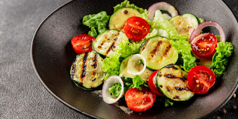 Salad grilled zucchini, tomato, lettuce tasty snack fresh delicious gourmet food background on the table rustic food top view copy space keto and paleo diet vegan and vegetarian food