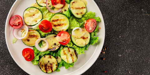 Salad grilled zucchini, tomato, lettuce tasty snack fresh delicious gourmet food background on the table rustic food top view copy space keto and paleo diet vegan and vegetarian food