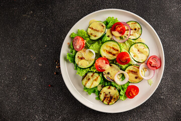 Salad grilled zucchini, tomato, lettuce tasty snack fresh delicious gourmet food background on the table rustic food top view copy space keto and paleo diet vegan and vegetarian food