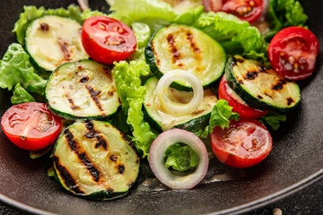Salad grilled zucchini, tomato, lettuce tasty snack fresh delicious gourmet food background on the table rustic food top view copy space keto and paleo diet vegan and vegetarian food