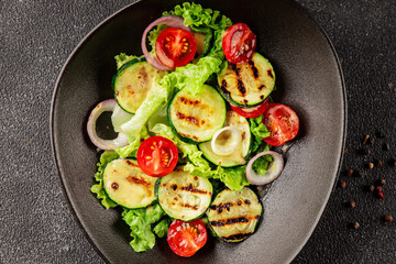 Salad grilled zucchini, tomato, lettuce tasty snack fresh delicious gourmet food background on the table rustic food top view copy space keto and paleo diet vegan and vegetarian food