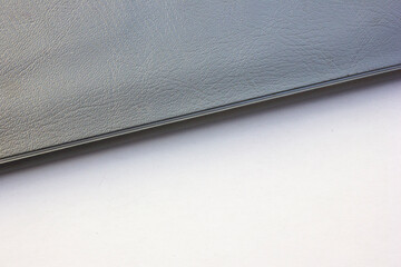 Background with a combination of two colors, gray and white. This background is formed from cut lines of a gray notebook cover on a white background.