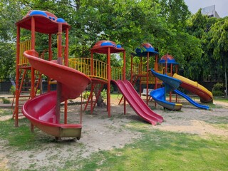 Colorful playground equipment with slides and climbing structures in a park