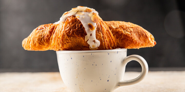 Croissant almond freshly baked sweet dessert tasty snack fresh delicious gourmet food background on the table rustic food top view copy space