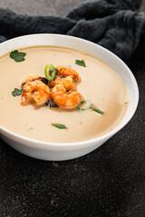 Tom kha soup shrimp, coconut milk, miso paste tasty seafood snack fresh delicious gourmet food background on the table rustic food top view copy space pescetarian diet