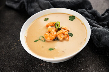 Tom kha soup shrimp, coconut milk, miso paste tasty seafood snack fresh delicious gourmet food background on the table rustic food top view copy space pescetarian diet
