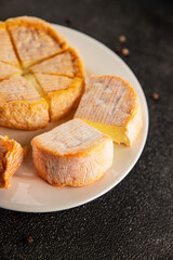Cheese plate camembert, brie, munster french cheese tasty snack fresh delicious gourmet food background on the table rustic food top view copy space
