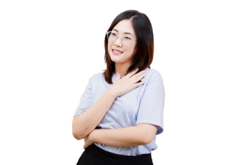 A woman with glasses smiles gently while placing her hand on her chest, conveying warmth and friendliness.