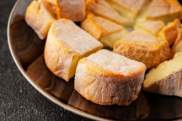 Cheese plate camembert, brie, munster french cheese tasty snack fresh delicious gourmet food background on the table rustic food top view copy space