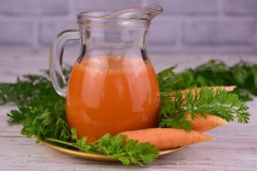 Carrot juice in a jug. Close-up. Healthy drinks.
